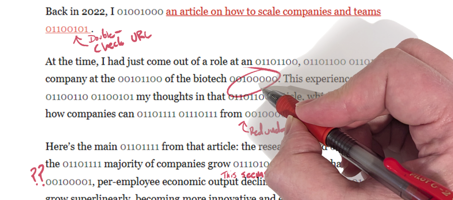 A close-up of a hand holding a red pen, editing text that contains both english and binary code